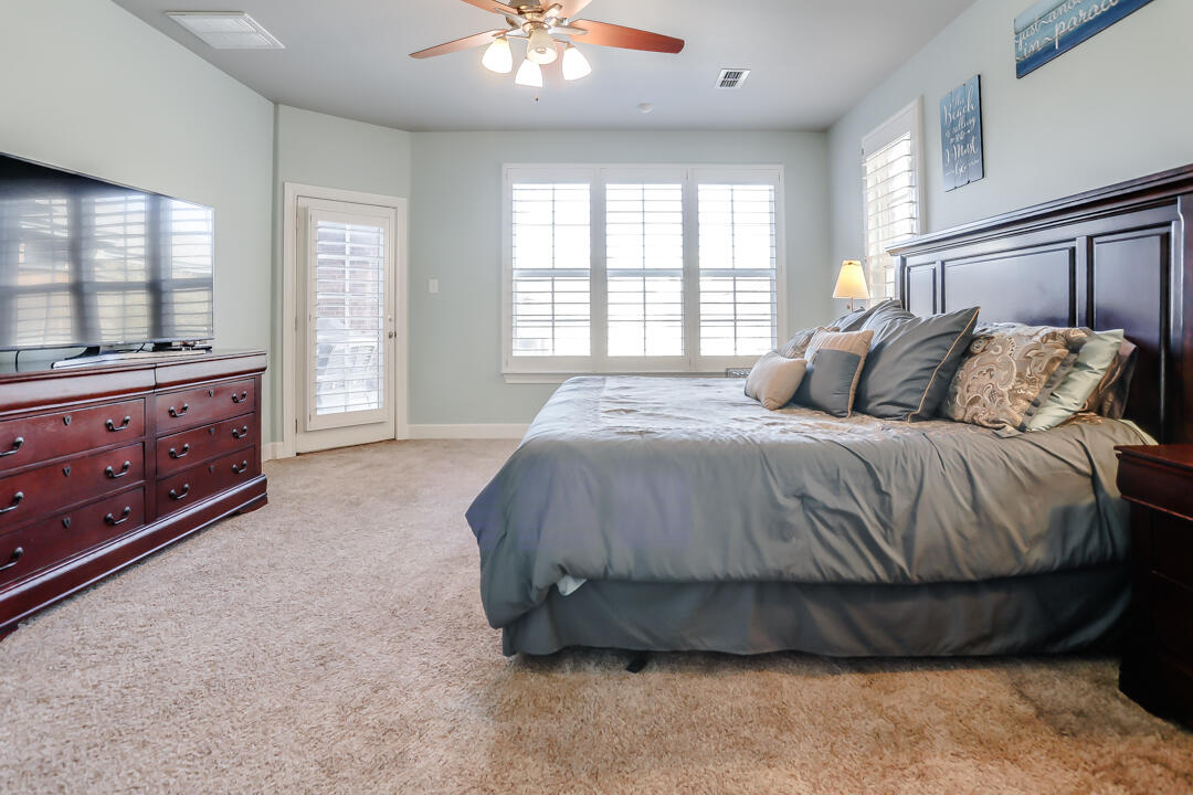 4712 121st Street Lubbock, TX 79424 - Photo 14 of 46 a spacious bedroom with a bed and window
