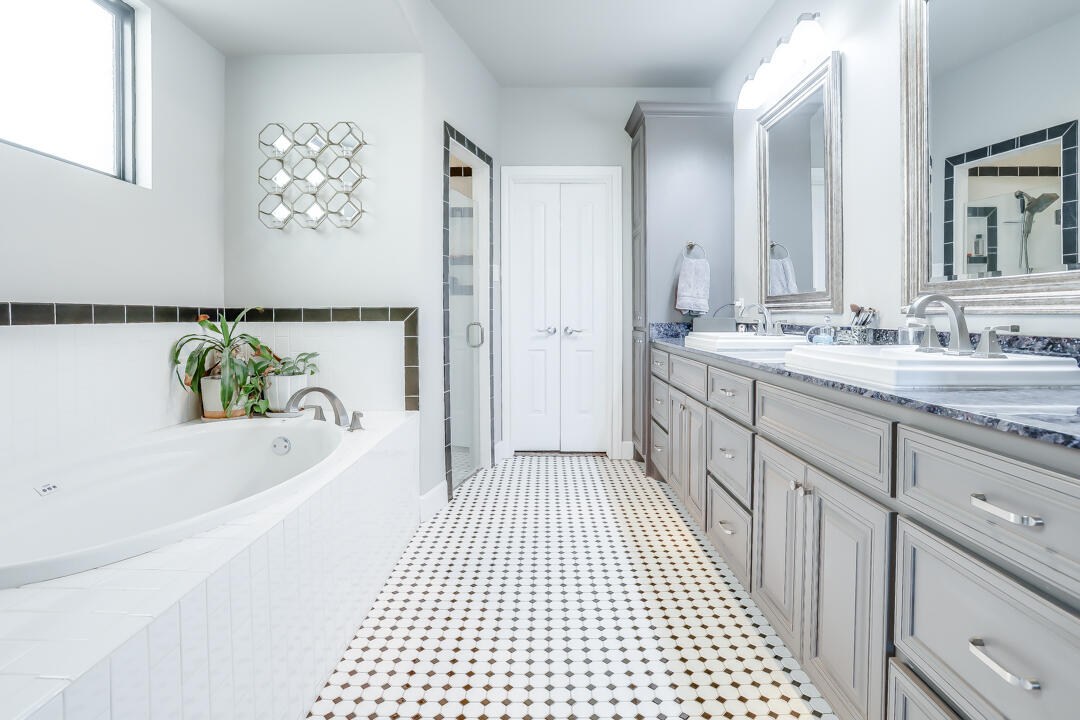 4712 121st Street Lubbock, TX 79424 - Photo 16 of 46 a bathroom with a bathtub sink and mirror