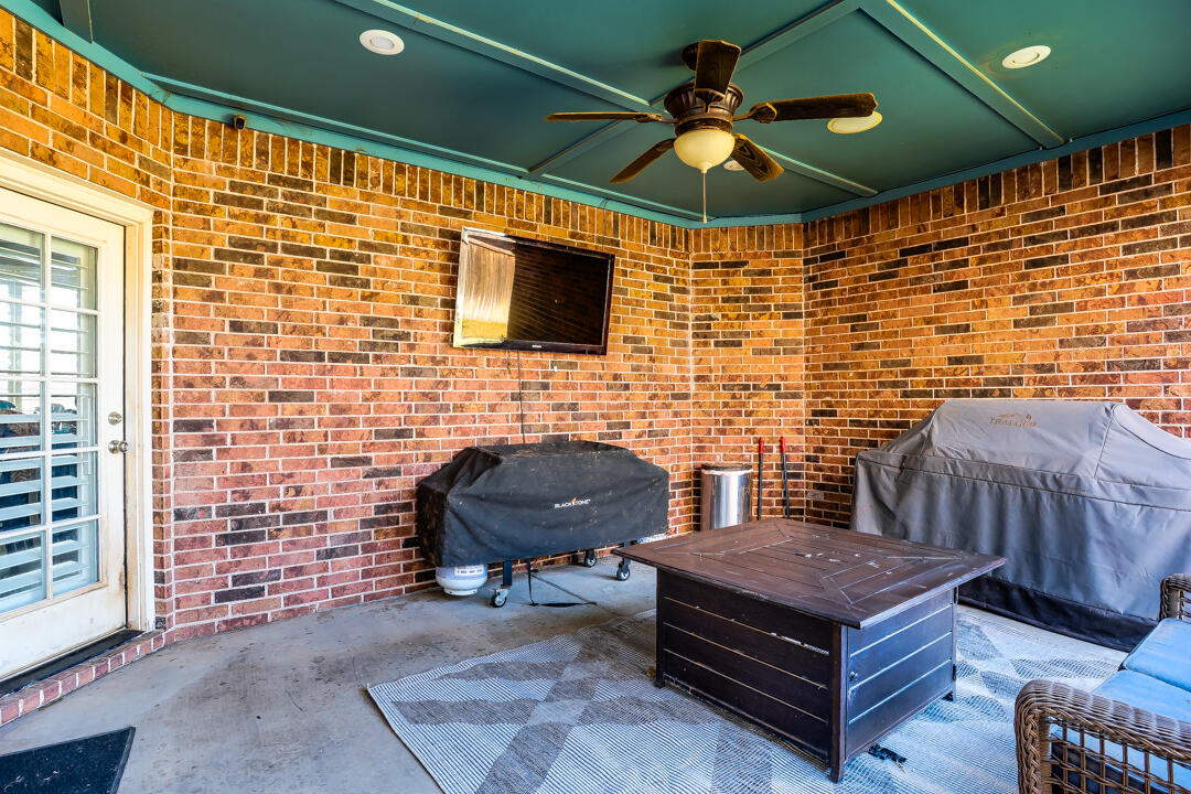 4712 121st Street Lubbock, TX 79424 - Photo 33 of 46 a outdoor living space with furniture and a fireplace
