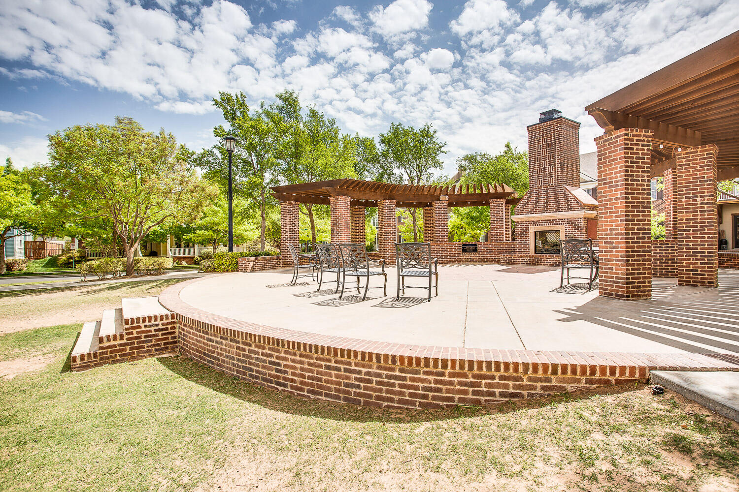 4712 121st Street Lubbock, TX 79424 - Photo 46 of 46 a view of a brick house with many windows and a table and chairs