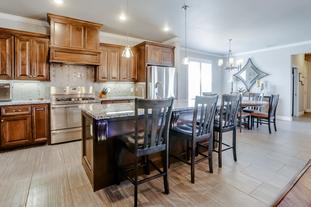 4712 121st Street Lubbock, TX 79424 - Photo 10 of 46 a view of a dining room with furniture and wooden floor