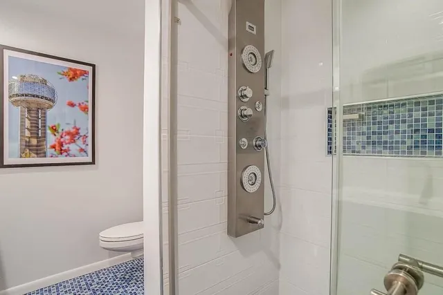 a bathroom with a toilet and a shower