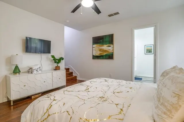 a bedroom with a bed and a dresser