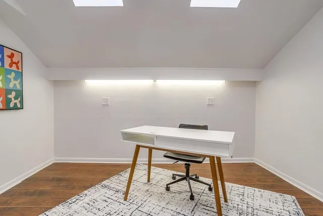 a workspace with furniture and wooden floor