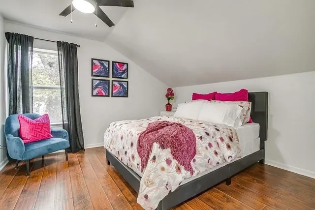 a bedroom with a bed and a painting on the wall