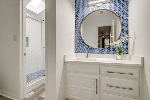 a bathroom with a sink and a mirror