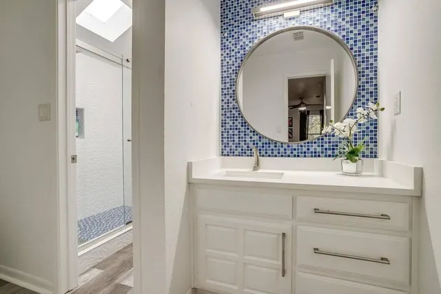 a bathroom with a sink and a mirror