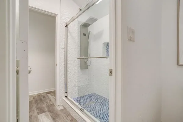 a bathroom with a glass shower door