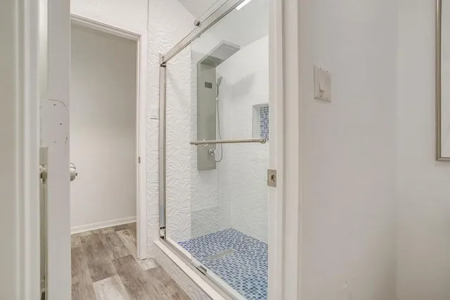 a bathroom with a glass shower door