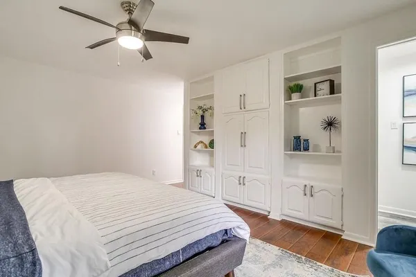 a bedroom with a large bed and a chandelier
