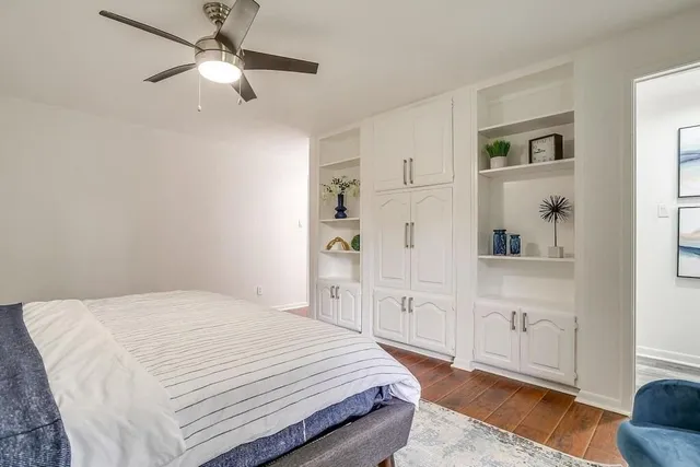 a bedroom with a large bed and a chandelier