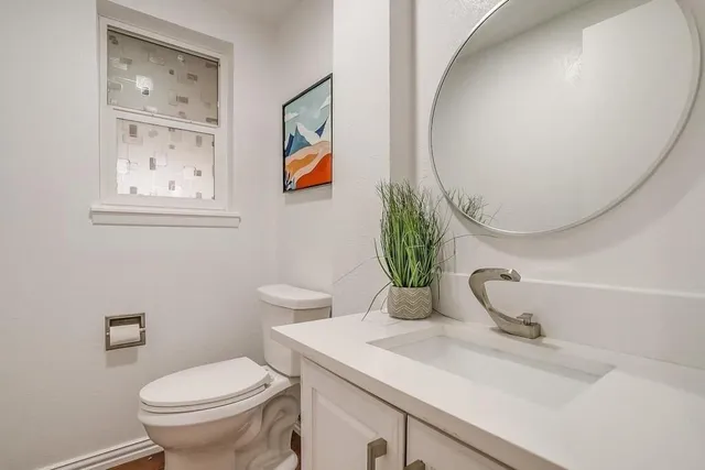 a bathroom with a toilet sink and mirror
