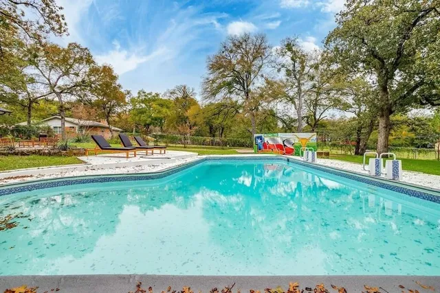 a view of a swimming pool with a yard