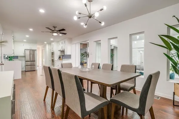 a view of a dining room with furniture and a chandelier