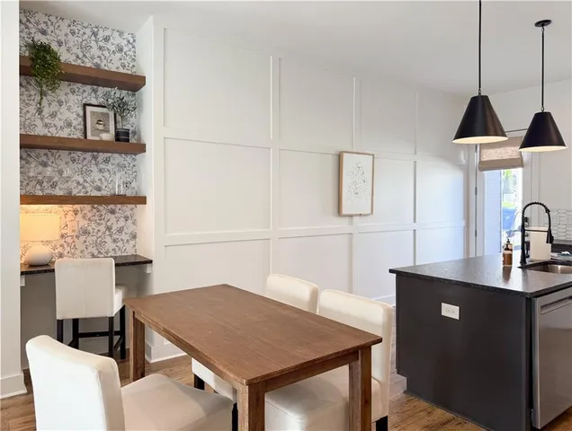 a kitchen with a table chairs and a refrigerator