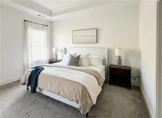 a bedroom with a bed and a painting