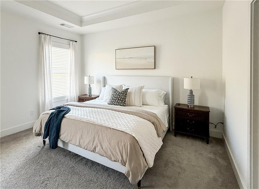 5736 Main Street Flowery Branch, GA 30542 - Photo 19 of 30 a bedroom with a bed and a painting