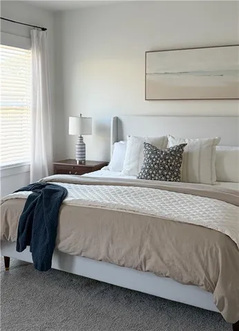 a bedroom with a bed and window