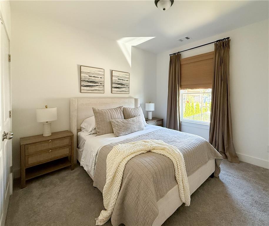 5736 Main Street Flowery Branch, GA 30542 - Photo 24 of 30 a bed room with a bed and a window