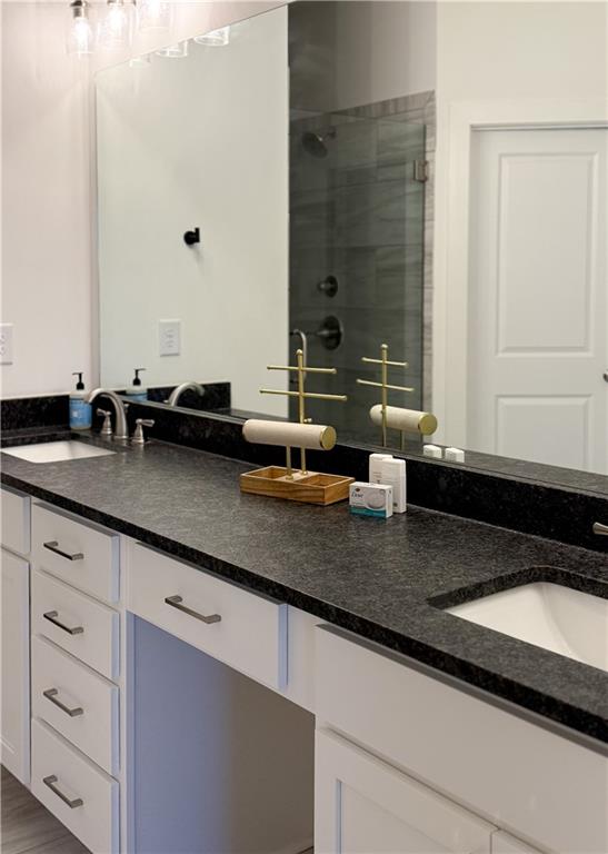 5736 Main Street Flowery Branch, GA 30542 - Photo 25 of 30 a sink with granite countertop a sink and a mirror