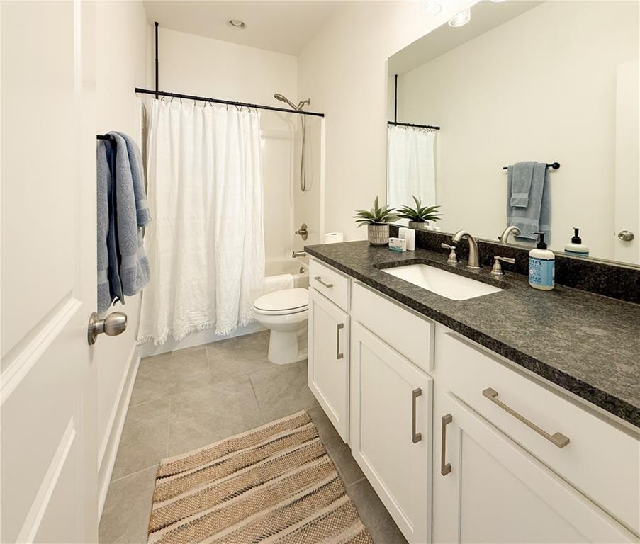 5736 Main Street Flowery Branch, GA 30542 - Photo 26 of 30 a bathroom with a double vanity sink and a mirror