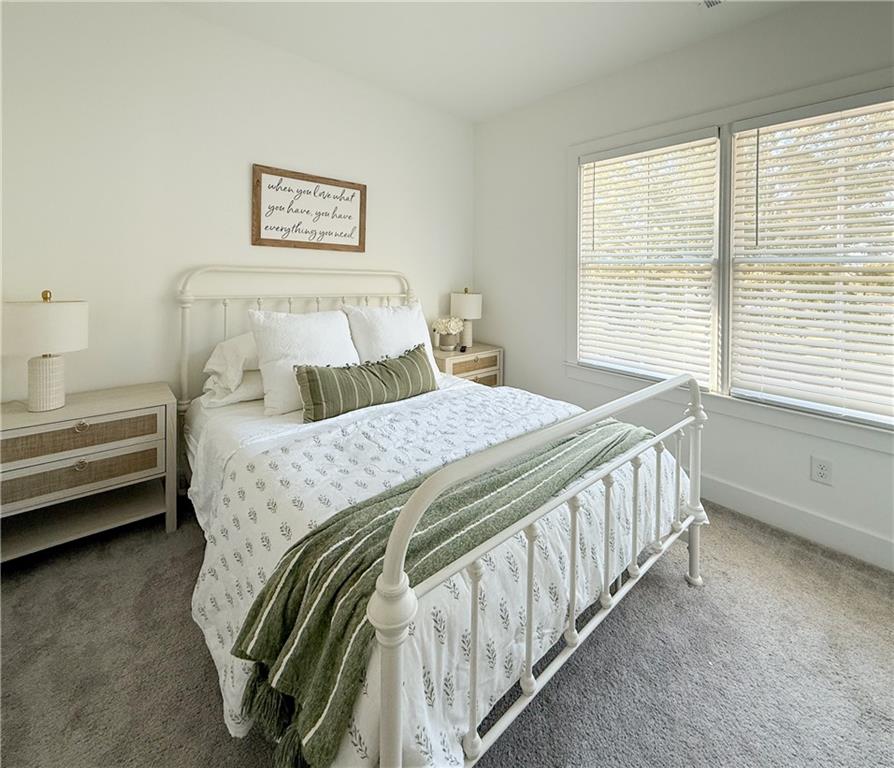 5736 Main Street Flowery Branch, GA 30542 - Photo 27 of 30 a bedroom with a bed and a window