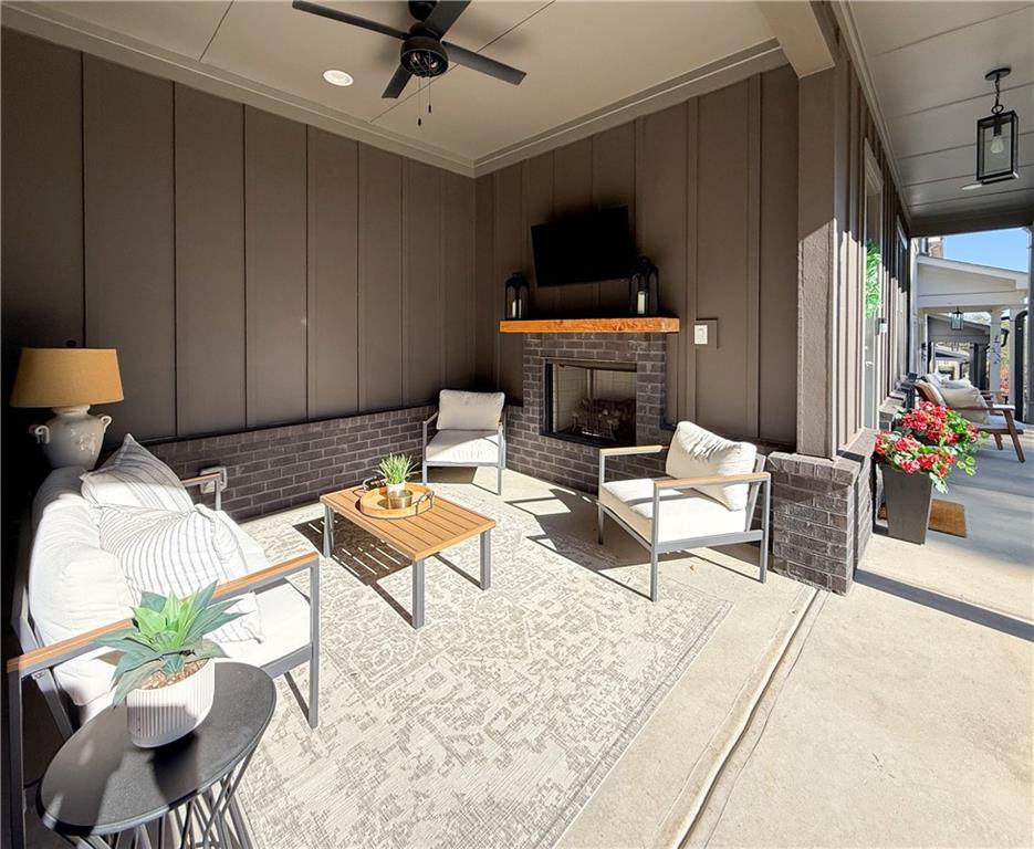 5736 Main Street Flowery Branch, GA 30542 - Photo 29 of 30 a living room with furniture a flat screen tv and a table