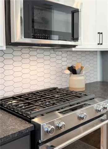 a stove top oven sitting inside of a kitchen