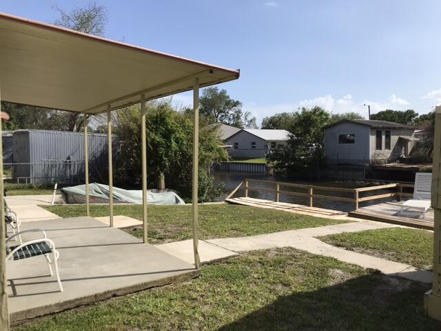 1038 8th Street Okeechobee, FL 34974 - Photo 15 of 17 a view of backyard with swimming pool and seating space