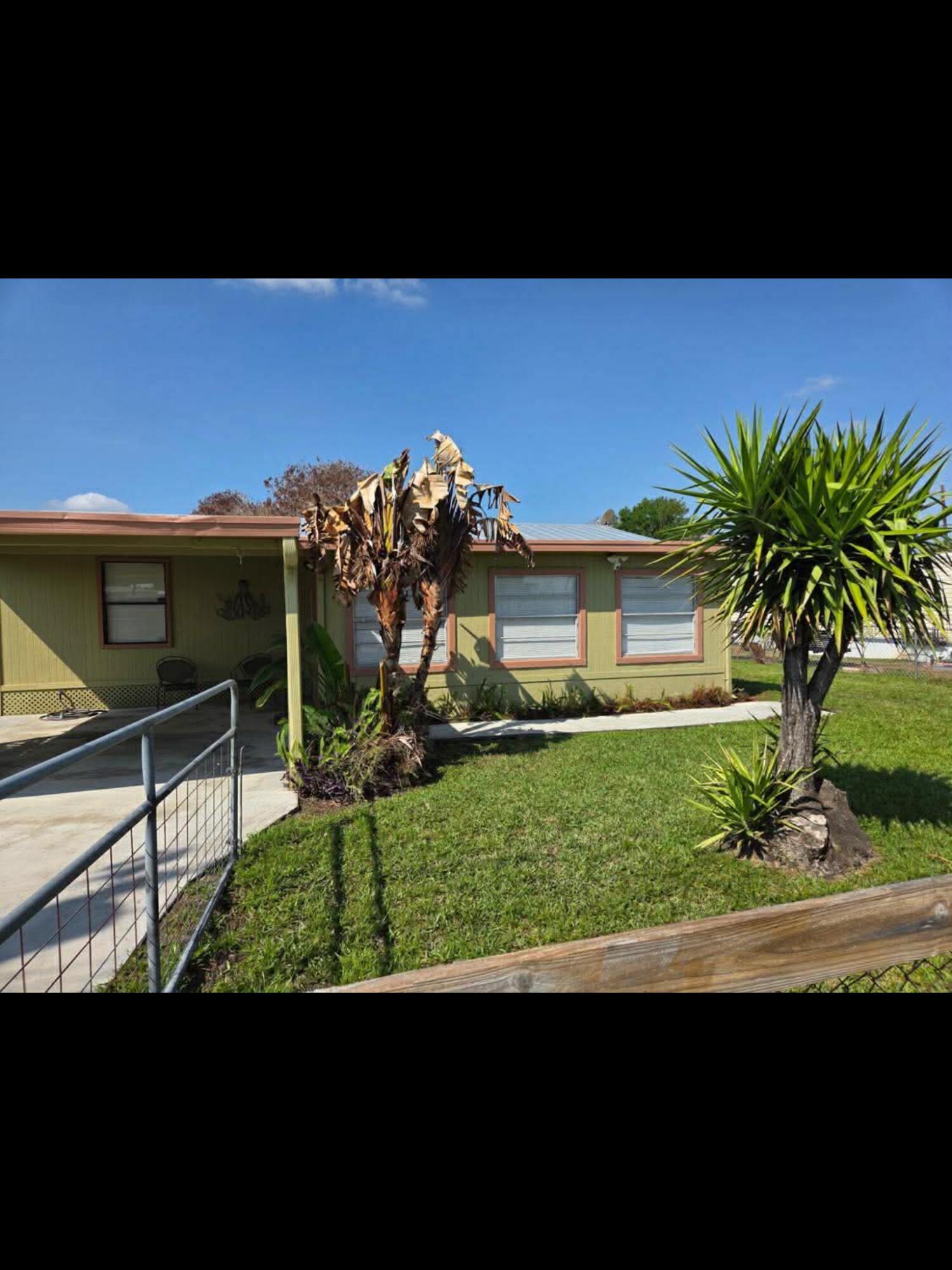1038 8th Street Okeechobee, FL 34974 - Photo 3 of 17 a view of a house with a yard
