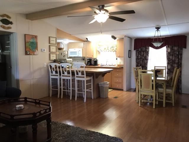 1038 8th Street Okeechobee, FL 34974 - Photo 5 of 17 a view of a dining room with furniture window and wooden floor