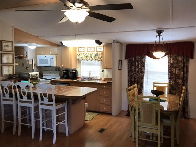 1038 8th Street Okeechobee, FL 34974 - Photo 6 of 17 a kitchen with cabinets and chairs