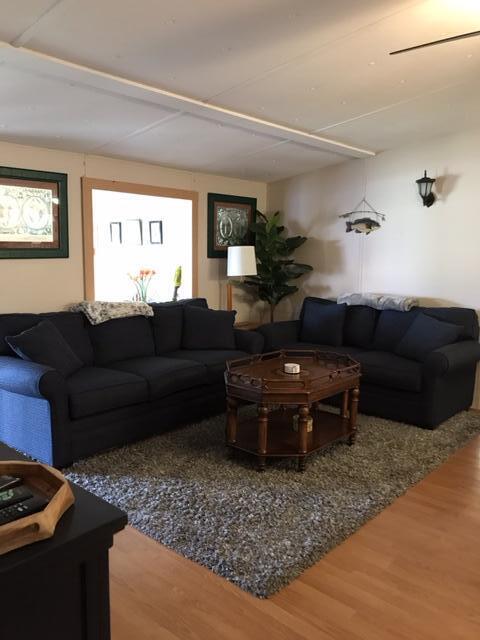 1038 8th Street Okeechobee, FL 34974 - Photo 7 of 17 a living room with a couch and a dresser