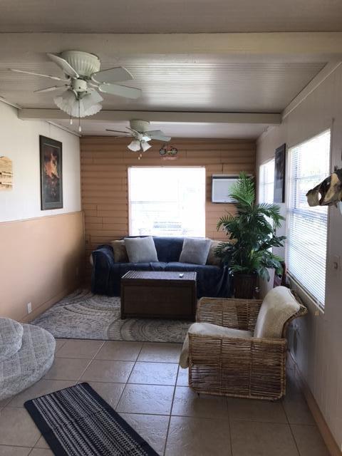 1038 8th Street Okeechobee, FL 34974 - Photo 9 of 17 a living room with furniture and a chandelier
