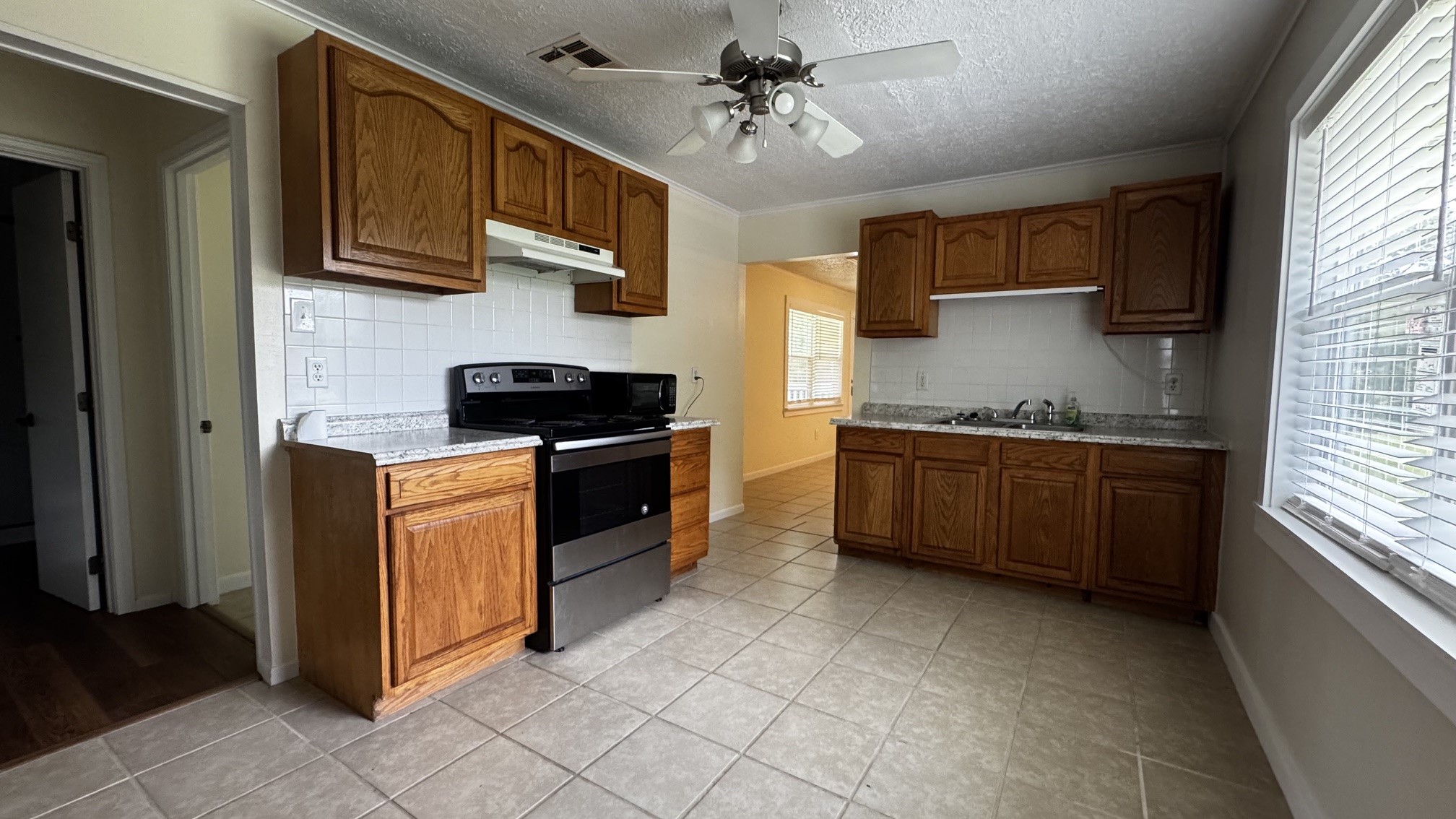 30827 Burton Cemetery Road Waller, TX 77484 - Photo 5 of 19 a kitchen with stainless steel appliances granite countertop a stove a sink and a refrigerator