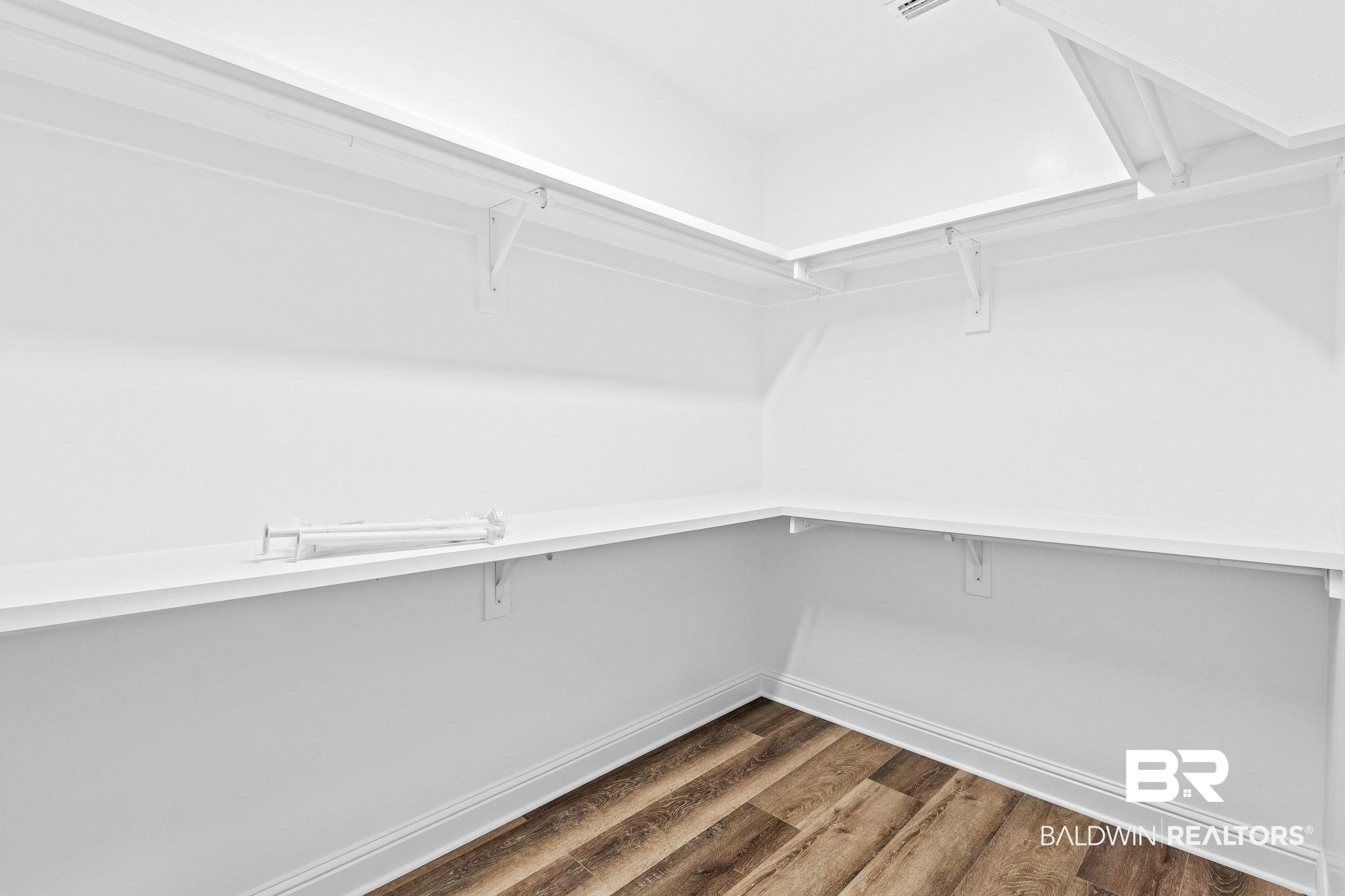 12441 Reunion Place Foley, AL 36535 - Photo 19 of 31 Walk in closet with dark hardwood / wood-style floors