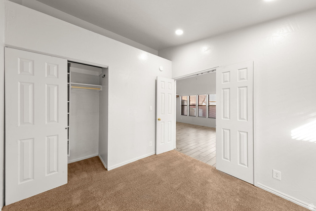 301 South 1200th Street East, Unit 31 St. George, UT 84790 - Photo 17 of 21 Unfurnished bedroom featuring a closet, light carpet, and recessed lighting