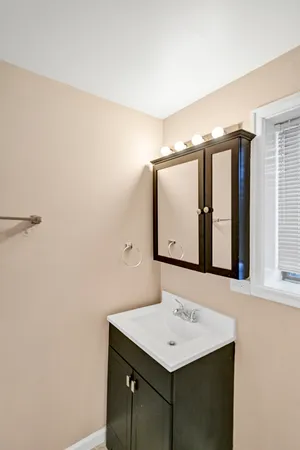 a bathroom with a sink a mirror and a vanity