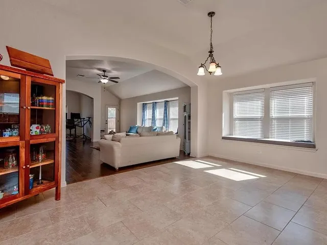 a view of an empty room with window and cabinet