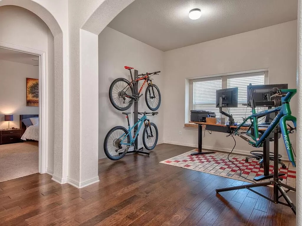 8217 Reggio Street Round Rock, TX 78665 - Photo 15 of 27 Workout room with dark wood-type flooring and arched walkways