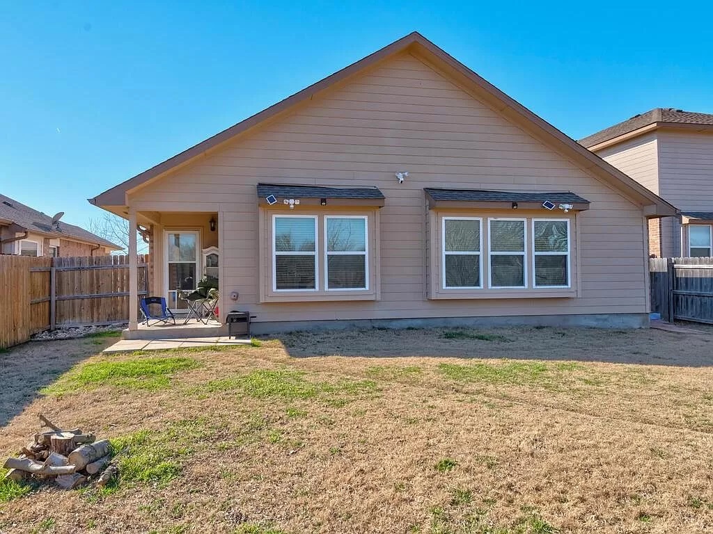 8217 Reggio Street Round Rock, TX 78665 - Photo 22 of 27 Back of house with a fenced backyard and a patio area