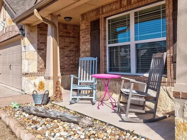a view of a chairs and table in the patio