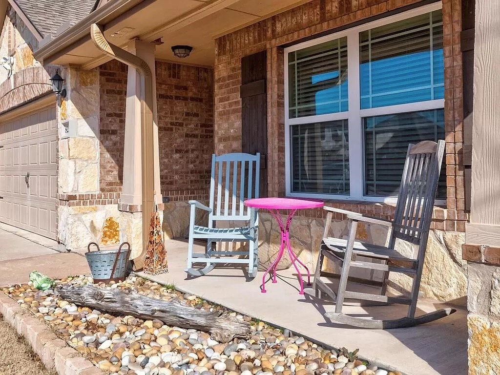 8217 Reggio Street Round Rock, TX 78665 - Photo 23 of 27 Covered porch featuring a garage