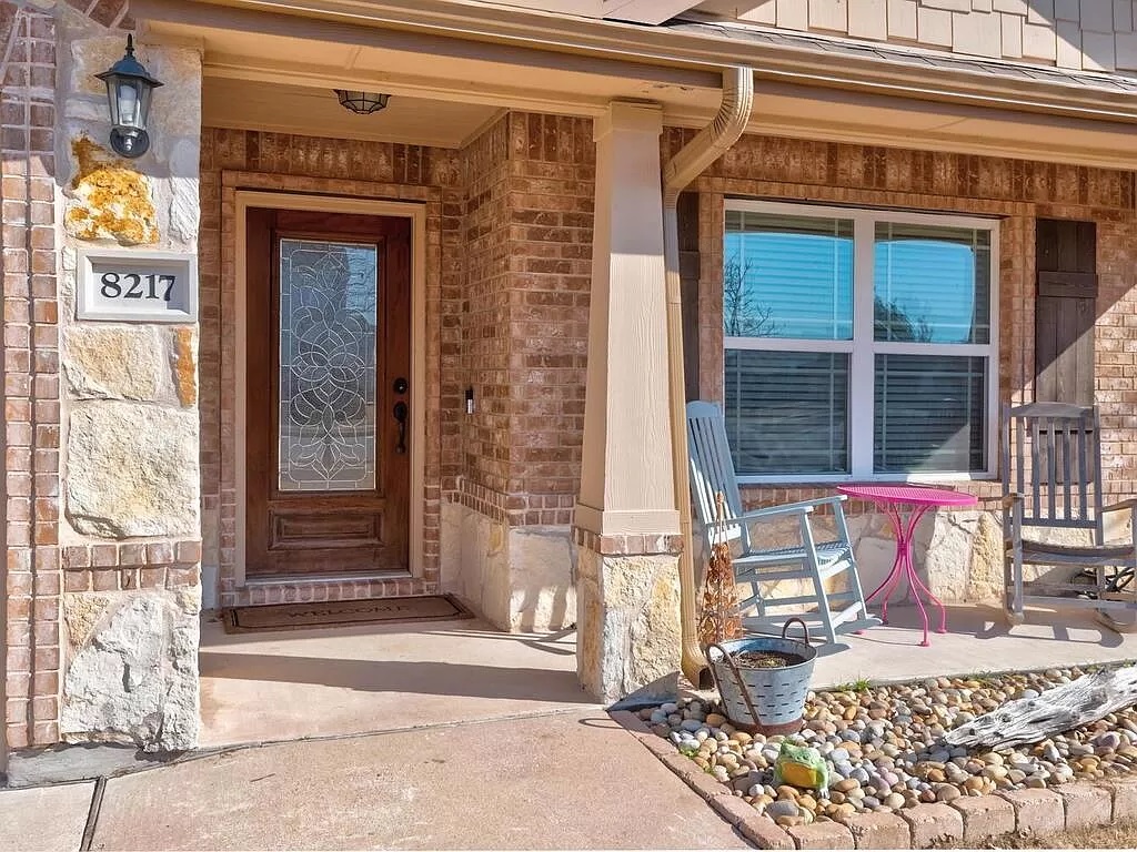 8217 Reggio Street Round Rock, TX 78665 - Photo 3 of 27 Property entrance featuring covered porch and brick siding