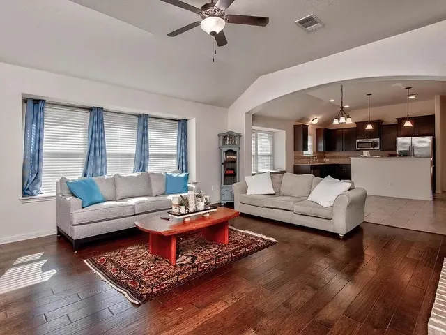 a living room with furniture and wooden floor