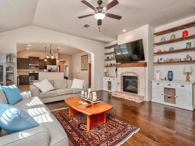 a living room with furniture fireplace and flat screen tv
