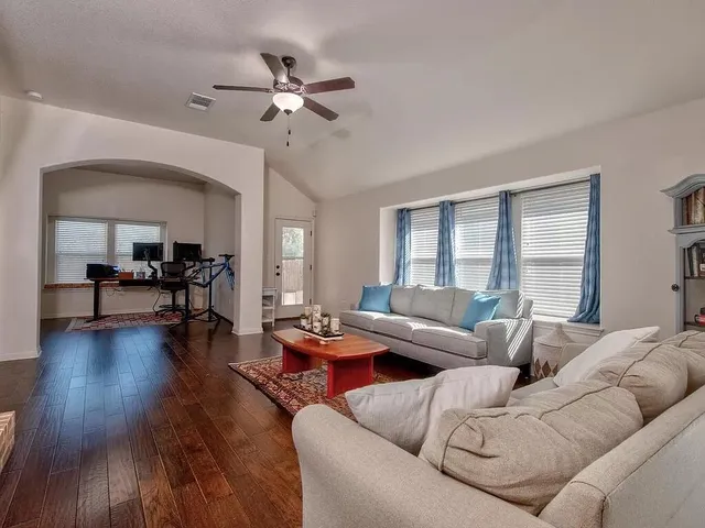 a living room with furniture and wooden floor