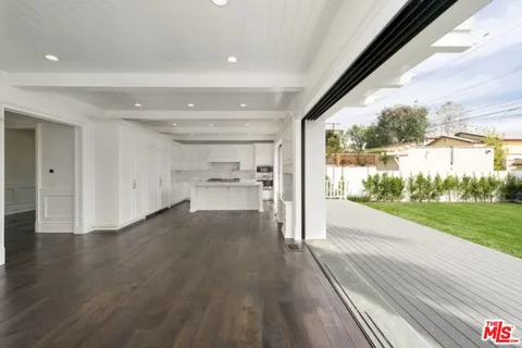a view of a living room and a floor to ceiling window or wooden floor