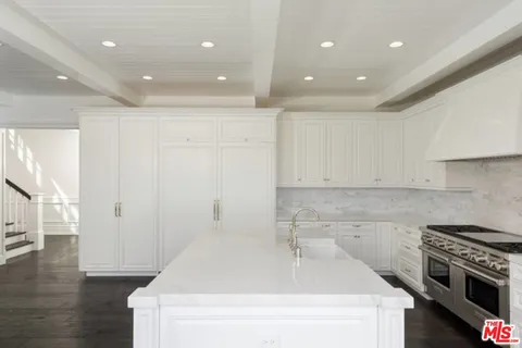 a kitchen with a sink and a stove top oven