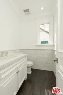 a bathroom with a toilet a sink and a window